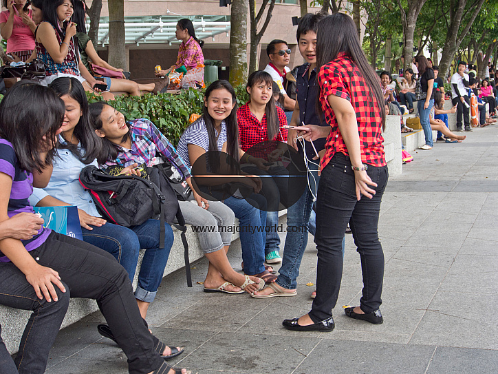 Migrant domestic workers enjoy a day off by the Bay side in Singapore
