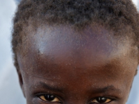 Young Haiti boy smiles at camera.