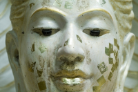 Thailand. Face of statue at a Buddhist temple.
