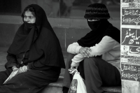  Two women sitting near the market area, Lahore.