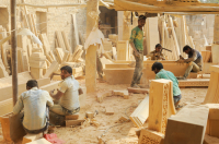 Craftsmen working in a sandstone workshop.