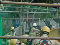 Migrant workers at a construction site by a highway in Singapore