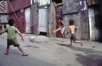 CHILDREN PLAYING FOOTBALL IN THE SHANTY TOWNS OF SANTOS, BRAZIL. Photo ¬© Julio Etchart