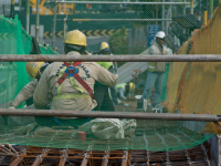 Migrant workers at a construction site by a highway in Singapore