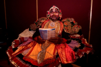 A South Indian dancer read a book before a stage show at a dance festival in Kolkata