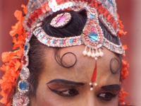A South Indian male dancer dressed like a woman smiles during a stage show at a dance festival in Kolkata, India