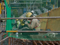 Migrant workers at a construction site by a highway in Singapore