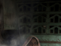 India. Woman cooking Iddly in South India.