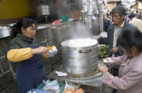 CHINA Vendors selling dumplings at the market place in a village in Yunnan province.