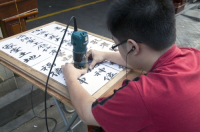 CHINA Sign-maker with calligraphic skills in the old quarter in Guangzhou, Guangdong province..