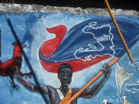 Colourful political mural painted on a street wall