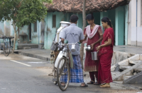 India. Women buying fresh milk in the morning.