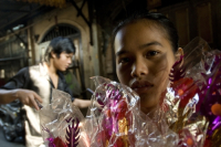 Thailnd. Girl selling flowers in Chinatown, Bangkok.