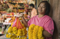 Thailand. Flower seller at temple in Chinatown. Bangkok.