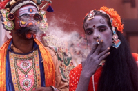 A South Indian dancer smokes cigarette during a short brake of stage show at a dance festival in Kolkata, India