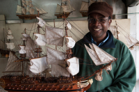 Mauritius. Harel Celestin holds one of the model boats he makes.