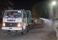 Workers Spray Disinfectant to Contain Coronavirus