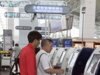 CHINA Passengers using automated checking in machines at the new terminal of the international airport of Guangzhou, Guangdong province.