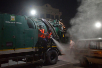 Workers Spray Disinfectant to Contain Coronavirus