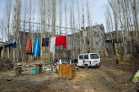 A backyard in Leh, Ladakh where clothes are hung to dry, water is stored and firewood is kept ready.