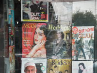  A man sitting outside a magazine store, Lahore